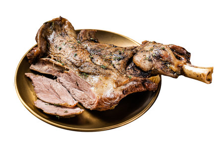 Baked whole lamb shoulder leg with herbs and spices in a plate. Isolated on white backgroundの写真素材