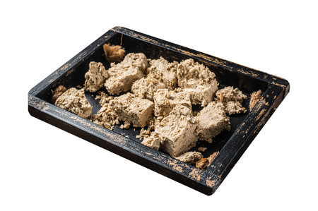 Halva with sunflower seeds and honey in wooden tray. Isolated on white background. Top viewの写真素材