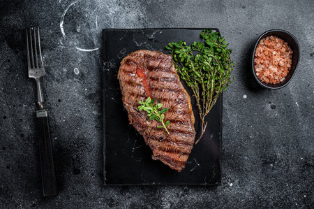 BBQ roasted Shoulder Top Blade or Australia wagyu oyster blade beef steak. Black background. Top View.の写真素材