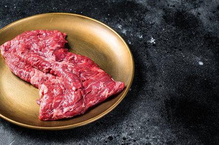 Alternative choice steak - Skirt or Machete, raw beef meat. Black background. Top view. Copy space.の写真素材