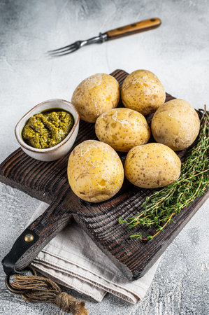 Canary Islands dish Papas Arrugadas, wrinkly potatoes with Mojo verde green sauce. White background. Top view.の写真素材