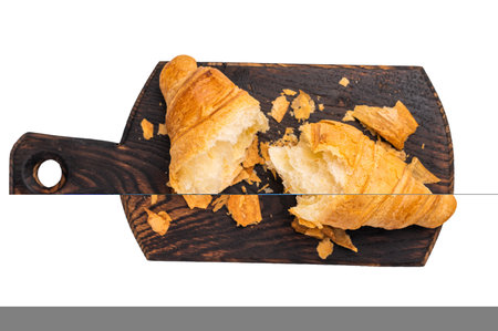 Broken fresh baked French croissant isolated on white background