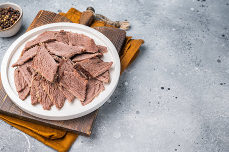 Corned sliced beef meat in a plate. gray background. top view.の写真素材