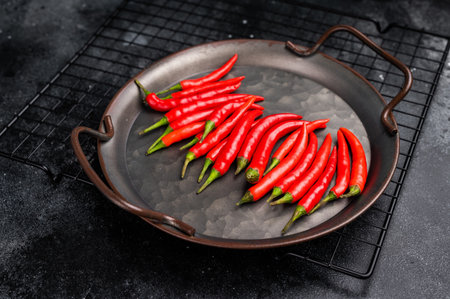 Hot Red chili peppers in a steel tray isolated on white background. top view.の写真素材