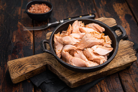 Cooked Roasted salmon fillet, Shredded fish meat in a skillet. wooden background. Top view.の写真素材