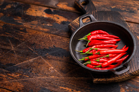 Freah Red chili peppers in a skillet isolated on white background. top view.の写真素材