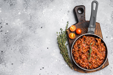 Italian bolognese sauce with ground beef in a pan. gray background. top view.の写真素材