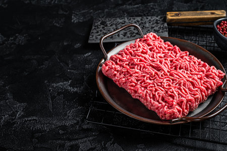 Raw beef and lamb Minced Meat, fresh ground meat. Black background. Top view. Space for text.