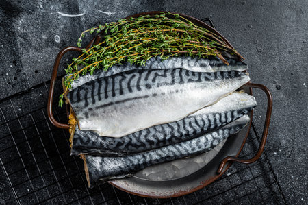 Raw Fresh fillet mackerel fish. Black background. Top view.の写真素材