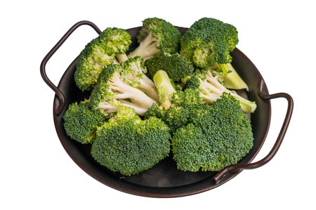 Green fresh broccoli pieces in a steel tray isolated on white background. top view.の写真素材