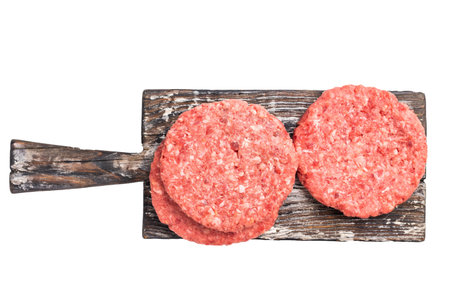 Raw pork and beef meat patties with herbs on wooden board isolated on white background.の写真素材