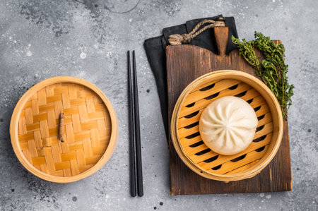 Chinese Bao or Baozi bun with meat in bamboo steamer. gray background. top view.の写真素材