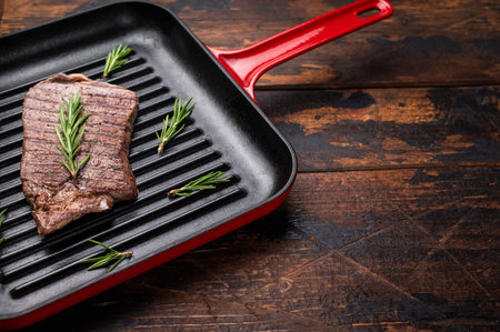 Grilled beef Top sirloin steak or Rump steak in grill pan. wooden background. top view.の写真素材