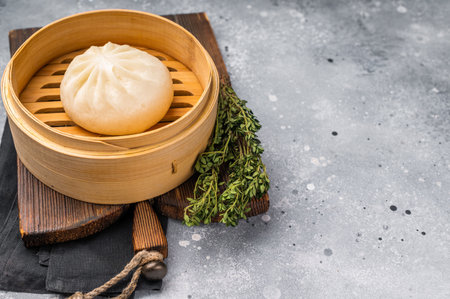 Chinese Bao or Baozi bun with meat in bamboo steamer. gray background. top view.の写真素材
