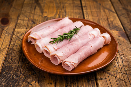 Italian Sliced Prosciutto Cotto ham on plate. wooden background. top view.の写真素材