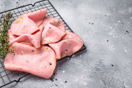 Slices Of Traditional Italian antipasti mortadella Bolognese. gray background. top view.