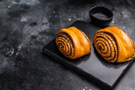 Sweet buns with poppy seeds. black background. top view.の写真素材