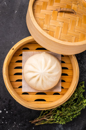 Chinese Bao or Baozi bun with meat in bamboo steamer. black background. top view.の写真素材