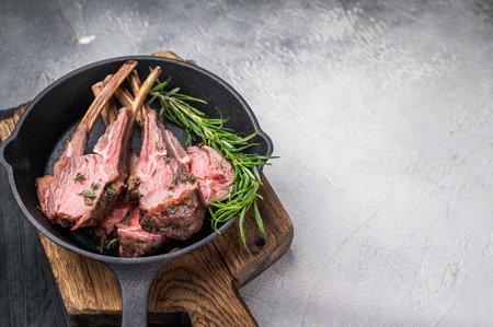 Roast lamb chops, mutton meat cutlets in a skillet. gray background. top view.の写真素材