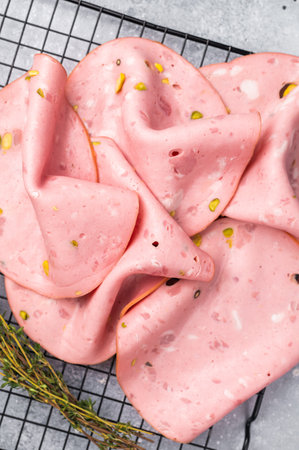 Slices Of Traditional Italian antipasti mortadella Bolognese. grey background. top view.の写真素材
