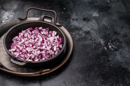 Chopped red onion slices in a black bowl. Black background. Top view.の写真素材
