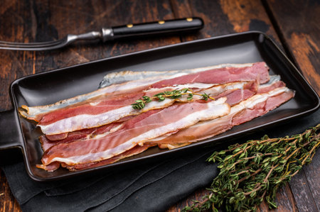 Smoked duck pastrami meat slices. wooden background. top view.の写真素材