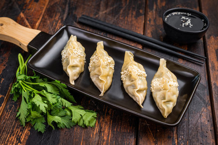 Steamed Korean Dumplings with pork meat and vegetables. wooden background. top view.の写真素材