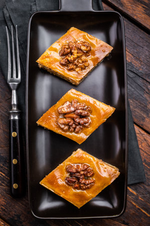 Homemade Walnut Baklava with honey on plate. wooden background. top view.の写真素材