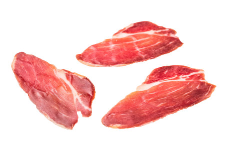 Slices of prsut, Balkan pork meat ham isolated on white background. top view.の写真素材