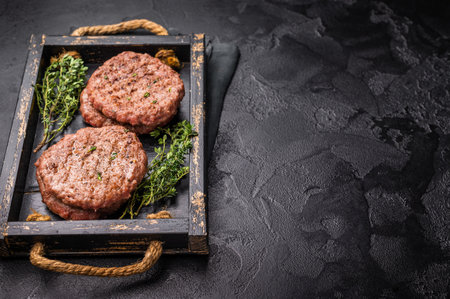 Grilled hamburger mince meat patties with herbs. black background. top view.の写真素材