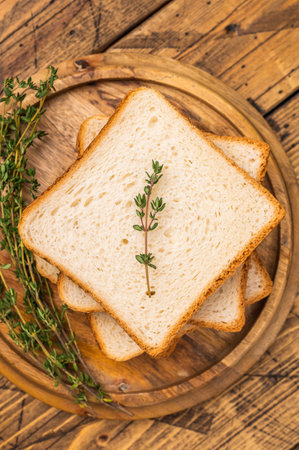 Ready for toasts Slices of wheat bread. wooden background. top view.