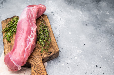 Pristine raw pork tenderloin, ideal for roasting or sautÃ©ing, promising tenderness in every bite. gray background. top view.の写真素材