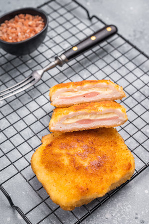 Fried Chicken cordon bleu cutlet with cheese and ham in breadcrumbs. grey background. top view.