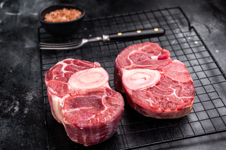Fresh raw ossobuco veal shank, ideal for slow cooking and creating hearty, comforting meals that impress. black background. top view.の写真素材