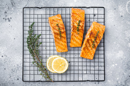 Grilled salmon fillet steak, roast fish on a rack. grey background. top view.の写真素材