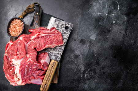 Beautifully marbled raw beef neck meat, perfect for enhancing your favorite recipes with rich flavors. black background. top view.の写真素材
