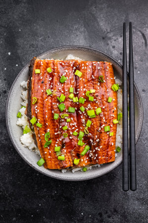 Unagi don, Unagidon Japanese grilled eel with rice in a bowl. black background. top view.の写真素材