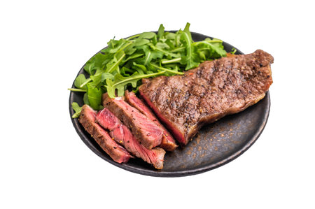 Grilled Striploin steak on a plate with salad, strip steak, prime roast beef meat isolated on white background.の写真素材