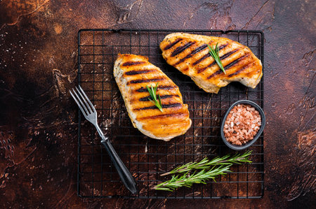 Eco Chicken grilled breasts, roasted poultry farm meat, top view, brown backgroundの写真素材