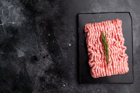 Raw ground pork meat, mincemeat. black background. top view.