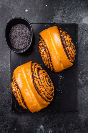 Sweet buns with poppy seeds. black background. top view.の写真素材
