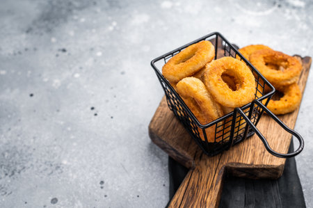 Deep Fried crunchy onion rings, delicious snack. gray background. top view.の写真素材