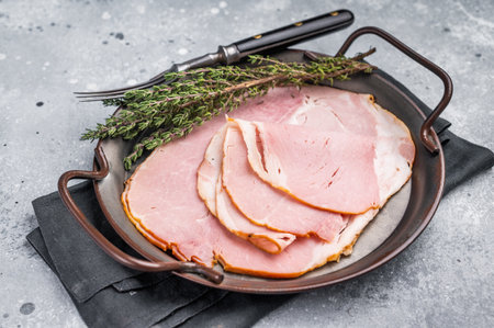 Thinly sliced pork ham, smoked meat. gray background. top view.の写真素材