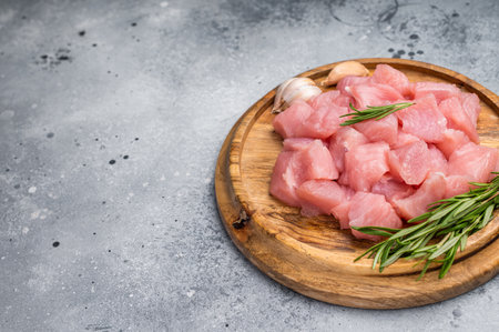 Diced raw turkey breast fillets, sliced poultry meat. gray background. top view.の写真素材