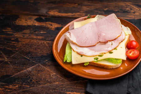 Ham and cheese sandwich, toast with sliced meat, cheese and salad. wooden background. top view.の写真素材