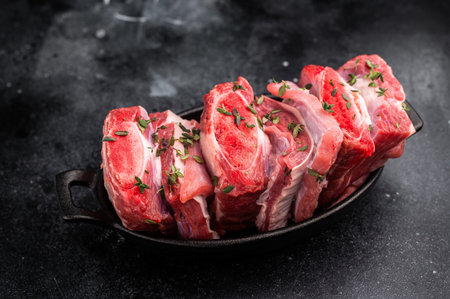 Raw Veal Short Ribs, fresh meat with thyme. black background. top view.の写真素材