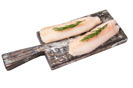 Raw cod Loin, white fish fillets without skin on wooden board isolated on white background.