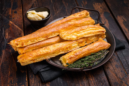 Homemade pastry, Bread sticks with cheese and salt. wooden background. top view.