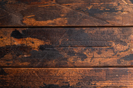 Rustic wooden background with dark burnt texture perfect for moody food photography and cozy kitchen compositionsの写真素材