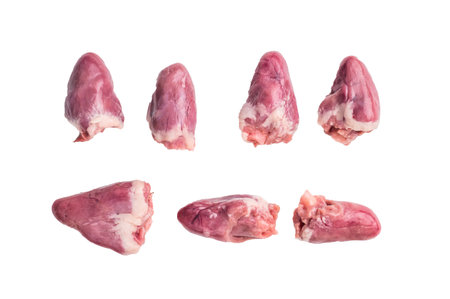 Pile of raw chicken hearts on a clean white background, perfect for culinary stock photosの写真素材